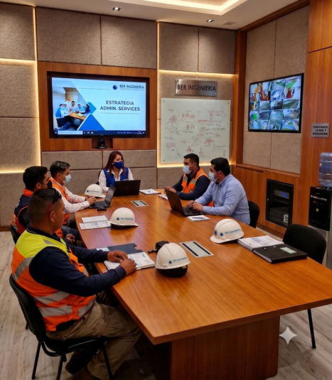 Equipo de ingeniería reunido revisando planos y proyectos